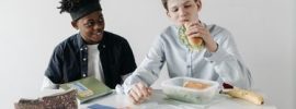 Boy eating a sandwich from a lunchbox